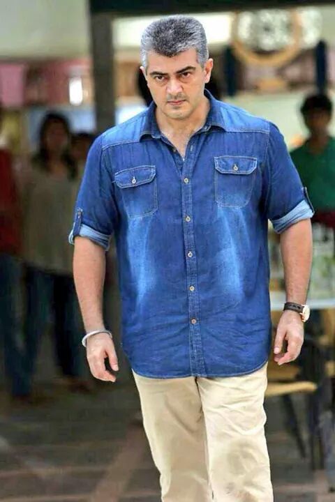 Ajith Kumar in blue denim shirt walking