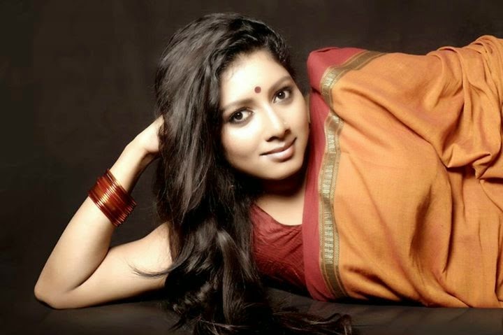Anumol in saree laying on floor for a photoshoot